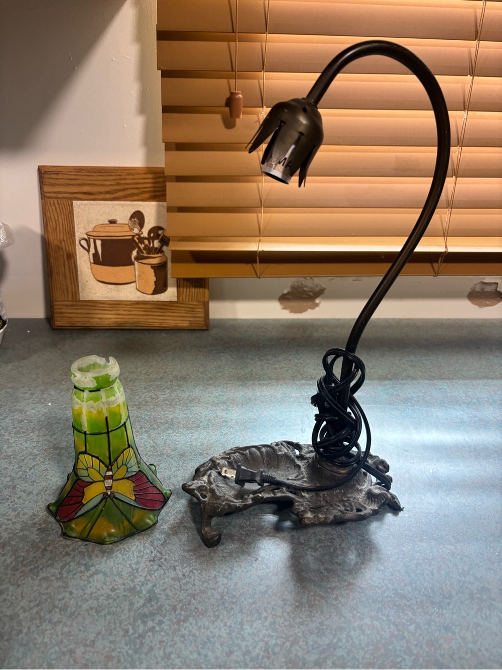 vintage Tiffany-style lamp with green glass shade, gooseneck arm